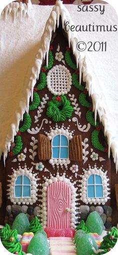 a gingerbread house is decorated with icing