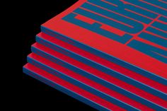 five red and blue books stacked on top of each other in front of a black background