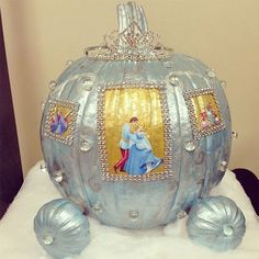 a blue pumpkin decorated with pictures and pearls