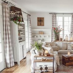 a living room filled with furniture and lots of windows