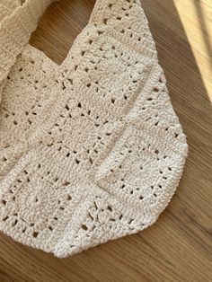 a crocheted bag sitting on top of a wooden floor