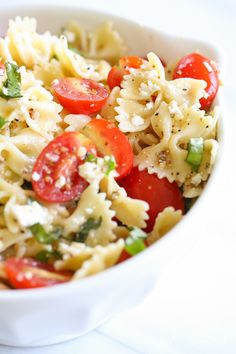 a white bowl filled with pasta and vegetables