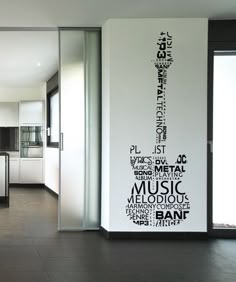 a kitchen with black and white wall decals on the walls