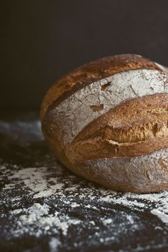 two loaves of bread sitting on top of a cutting board