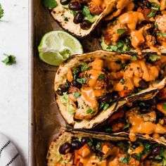 chicken tacos with black beans, avocado and cilantro sauce