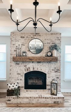 a living room filled with furniture and a fire place under a mirror on top of a mantle