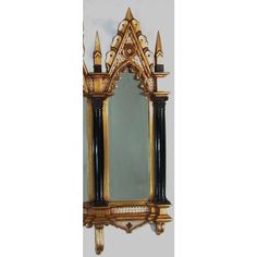 an ornate gold and black mirror on the wall