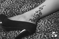 a woman's foot with a tattoo on it and an animal print design in the middle