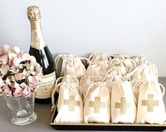 a bottle of wine and some bags with flowers in them