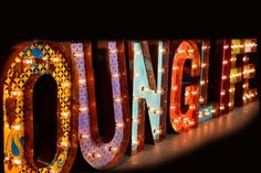 an illuminated sign that reads, `'the word jungle is surrounded by lights