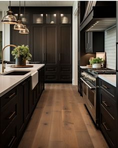 a kitchen with dark wood cabinets and white counter tops