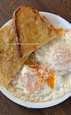 two pieces of toast on a plate with an egg in the middle and some cheese