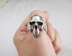 Solid Skull Solid Sterling Silver ring, size 10.5, biker ring Solid Skull Sterling Silver Ring.  Rock/punk/ biker style bold ring.  Looking so cool when you are riding your bike. A wonderful gift ring for your special man. Ring size:  10.5 Skull size is about 11/16" inch wide X 1" inch long. Rear ring band size: 6mm Total weight:  12.7 grams Condition:  very good almost like new (early 1990's jewelry store old inventory stock; unused item.)   Hallmark:  925 Material:  Sterling silver (925) Estim Punk Style Skull Rings For Biker Events, Biker Skull Ring For Biker Events, Man Ring, Biker Rings, Bold Rings, Rock Punk, Sterling Silver Dangle Earrings, Gift Ring, Biker Style