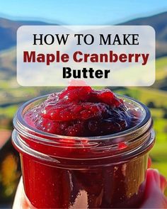 a hand holding a jar filled with cranberry butter and the words how to make maple cranberry butter