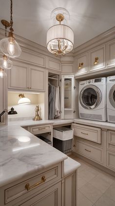 a washer and dryer sitting in a room next to a counter with lights