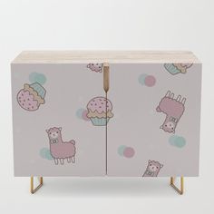 an image of a pink cabinet with llamas and cupcakes on it