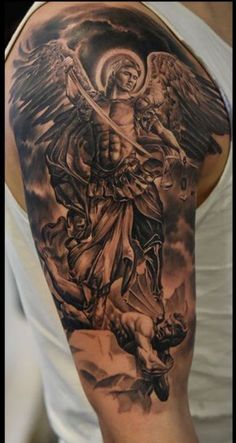 a man's arm with an angel and demon tattoo on the back of it