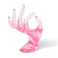 a pink glass sculpture is shown against a white background