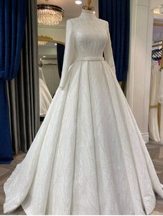 a white wedding dress on display in a store