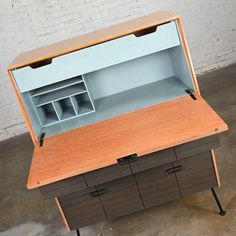 an open wooden cabinet with drawers and shelves