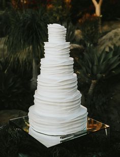 a white wedding cake sitting on top of a table