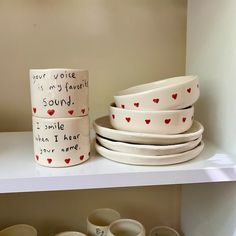 a shelf with bowls and cups on it