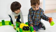 two children playing with toys on the floor