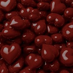 a pile of red heart shaped chocolate candies