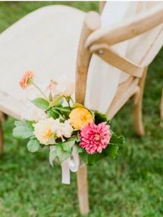 a bouquet of flowers sitting on top of a wooden chair