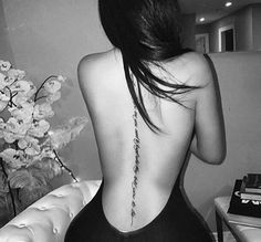 the back of a woman's body is shown in black and white