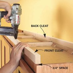 a person using a power tool to attach cabinet drawers