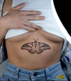 a woman with a butterfly tattoo on her stomach