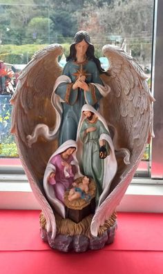 a figurine of an angel holding a baby jesus