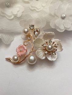 Brighten up any outfit with this beautiful faux pearl, rhinestone and resin cherry blossom brooch!  The cherry blossom flowers have dimension and texture and the faux pearl and teardrop rhinestone accents only add to the beauty! Brooch is approximately 1-7/8" tall and 2" wide. Not intended for children ages 13 and under.   Also, for many items we can accommodate large orders, so please send us a message. Elegant Pink Wedding Brooches, Elegant Pink Flower Pins, White Flower Pins For Wedding, Flower Shaped Wedding Brooch Pin, White Flower-shaped Wedding Pins, Elegant Flower-shaped Wedding Pins, Elegant Flower Wedding Pins, Pink Flower Brooch For Wedding, Pink Wedding Brooch With Flower Decoration