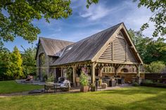 a large wooden building sitting on top of a lush green field