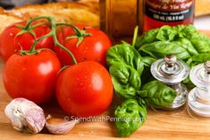 tomatoes, basil and garlic on a cutting board