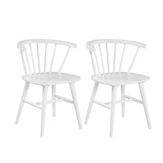 two white chairs sitting next to each other