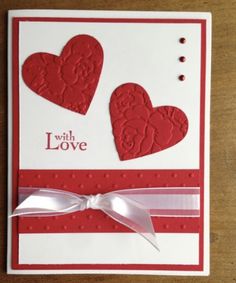 a valentine's day card with two hearts on it and a ribbon tied around the edge