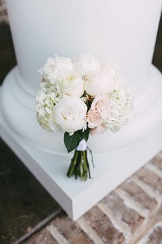 a white wedding cake with flowers on top