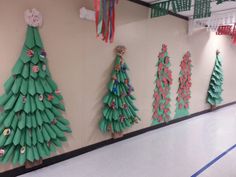 several paper christmas trees are hanging on the wall