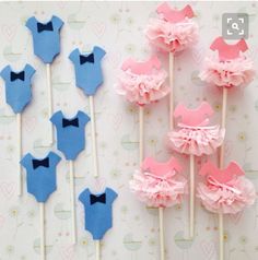 there are some cake pops with pink and blue decorations on them next to each other