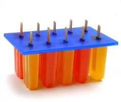 an orange, yellow and blue plastic object with screws on the top is shown