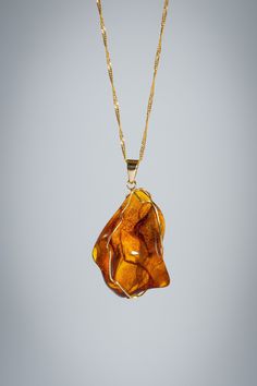 18k solid gold necklace with a stunning raw amber stone wrapped in solid gold wiring pendant. Chain length: 22 inches Chain weight: 1.83 grams  Pendant weight: 1.65 grams Polished 14k Gold Amber Jewelry, 14k Gold Amber Jewelry With Polished Finish, Baltic Amber Gemstone Necklaces, Handmade Baltic Amber Gold Necklaces, Elegant Yellow Baltic Amber Necklaces, Amber Pendant Necklace In Baltic Amber, Gold Teardrop Pendant Necklace With Wire Wrapped, Gold Pendant Necklace With Baltic Amber, Baltic Amber Pendant Necklace