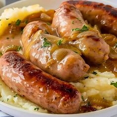 two sausages and mashed potatoes in a bowl