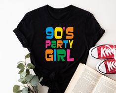 This t-shirt is the perfect choice for anyone attending an 90s-themed party or event. The shirt features a crew neck and short sleeves, making it a comfortable option for any occasion. The graphic tee design showcases the phrase "This Is My 90s Costume" in a fun and festive font. Made from soft and durable cotton jersey fabric, this regular fit t-shirt is machine washable for easy care. Whether you're dressing up for a wedding, party, or simply casual wear, this t-shirt will be a hit. So channel 1980s Fancy Dress, 80s Costume, Party Girl, Graphic Tee Design, Girl T Shirt, Retro Shirts, Party Girls, Showcase Design, Themed Party