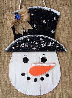 a snowman made out of wood with the words let it snow