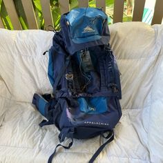 a blue backpack sitting on top of a bed