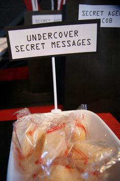 there is a sign that says undercover secret messages in plastic bags next to some cookies