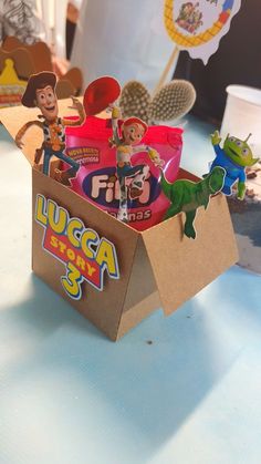 a cardboard box filled with candy on top of a table