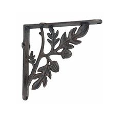 an iron shelf bracket with leaves on it